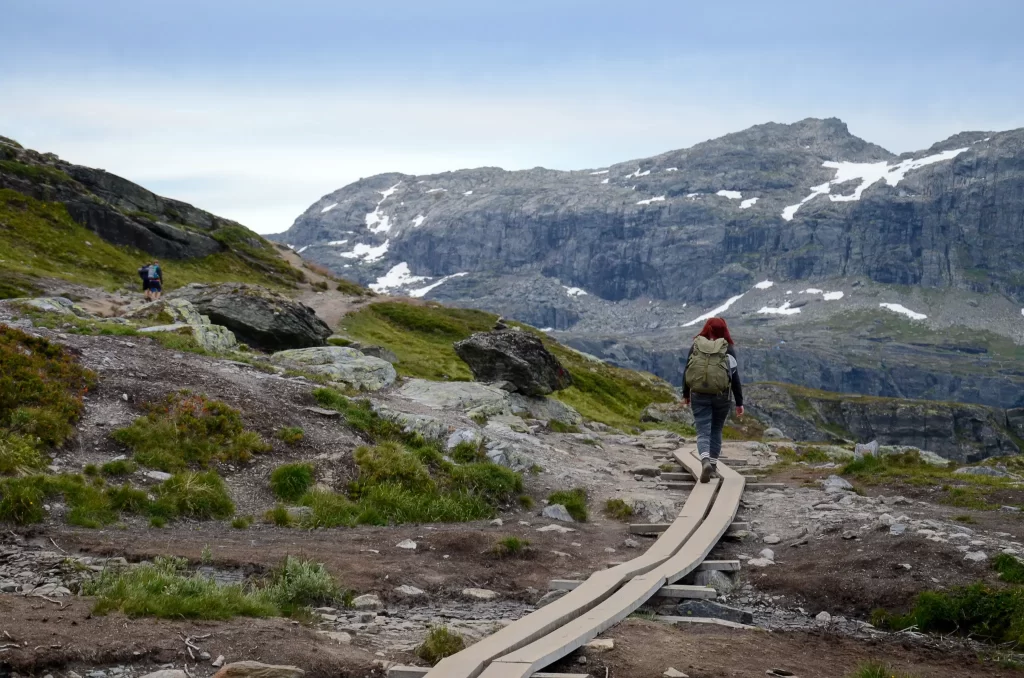 Hiker walking along the Trolltunga trail in the Hardangerfjord region of Western Norway.