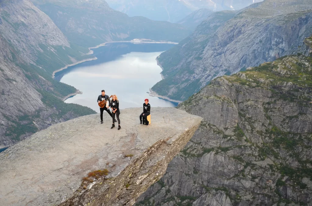 Band filming a music video on Trolltunga rock above Ringedalsvatnet early in the morning.